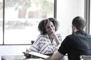 Mature businesswoman talks withe male colleague